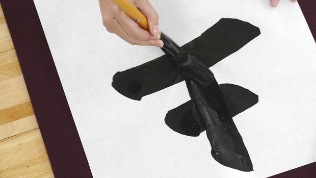 Participants show their traditional Japanese calligraphy during the annual New Year's calligraphy contest at the Budokan martial arts hall Thursday, Jan. 5, 2023, in Tokyo. (AP Photo/Eugene Hoshiko)
