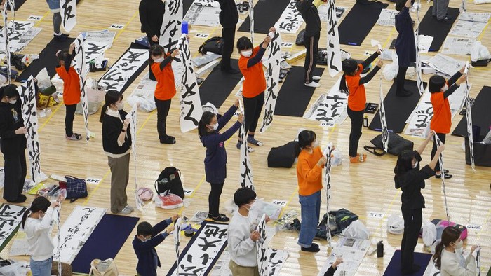 Participants show their traditional Japanese calligraphy during the annual New Year's calligraphy contest at the Budokan martial arts hall Thursday, Jan. 5, 2023, in Tokyo. (AP Photo/Eugene Hoshiko)