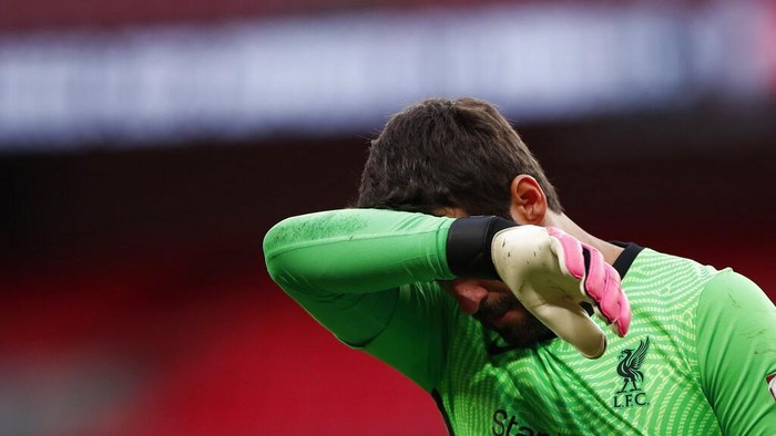 Liverpool goalkeeper Alisson Becker reacts during the penalty shootout during the English FA Community Shield soccer match between Arsenal and Liverpool at Wembley stadium in London, Saturday, Aug. 29, 2020. (Andrew Couldridge/Pool via AP)
