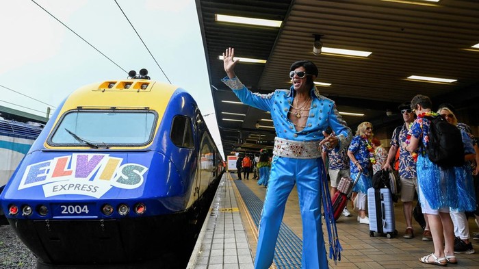 An Elvis Presley impersonator waves before boarding a train at Sydney Central Railway Station departing for the Parkes Elvis Festival, in Sydney, Australia, January 5, 2023. REUTERS/Jaimi Joy
