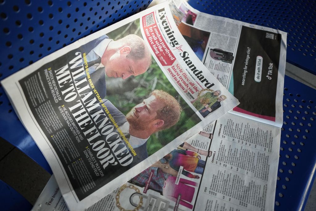 A newspaper showing Britain's Prince Harry and Prince William on the front page lies discarded on a bench in London, Friday, Jan. 6, 2023. Prince Harry alleges in a much-anticipated new memoir that his brother Prince William lashed out and physically attacked him during a furious argument over the brothers' deteriorating relationship. The book 