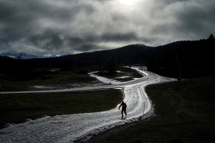 A man practices nordic skiing despite the lack of snow in La Feclaz, near Chambery, in the French Alps, Thursday, Jan. 5, 2023. (AP Photo/Laurent Cipriani)