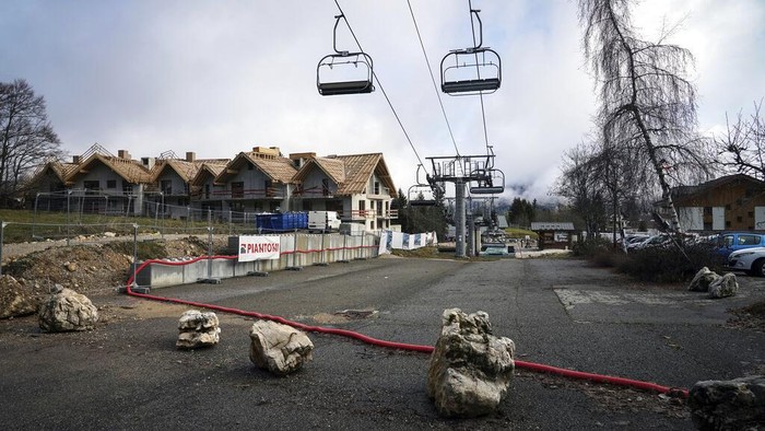 A man practices nordic skiing despite the lack of snow in La Feclaz, near Chambery, in the French Alps, Thursday, Jan. 5, 2023. (AP Photo/Laurent Cipriani)