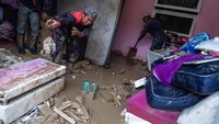 Warga dibantu TNI-Polri hingga relawan membersihkan rumah dan barang-barang dari lumpur.