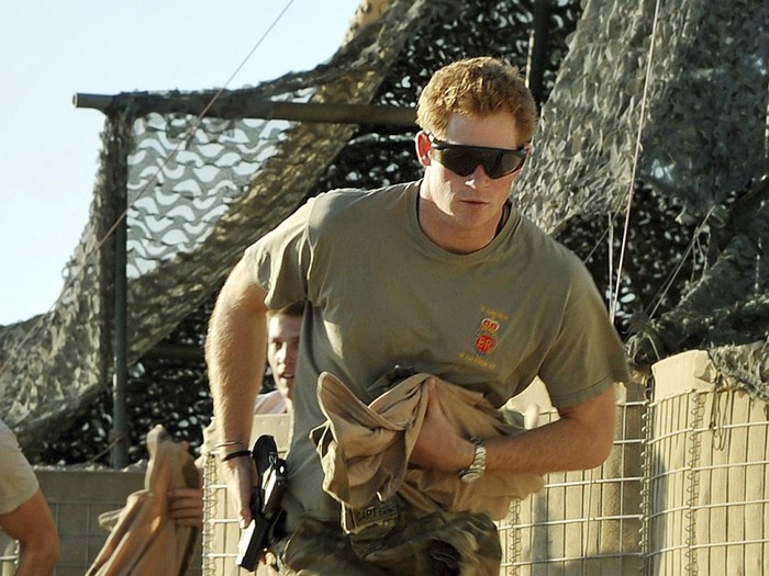 FILE - Britains Prince Harry races out from the VHR (very high ready-ness) tent to scramble his Apache with fellow Pilots, during his 12 hour shift at the British controlled flight-line in Camp Bastion southern Afghanistan, Nov. 3, 2012. Prince Harry alleges in a much-anticipated new memoir that his brother Prince William lashed out and physically attacked him during a furious argument over the brothers’ deteriorating relationship. The book “Spare