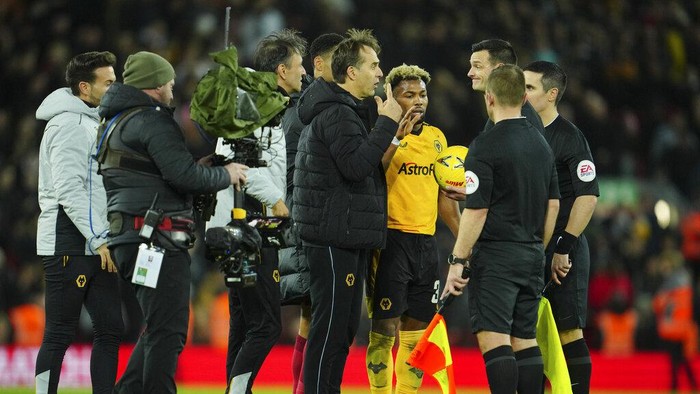 Wolverhampton Wanderers coach Julen Lopetegui, centre, speaks to referee Andy Madley after the English FA Cup soccer match between Liverpool and Wolverhampton Wanderers at Anfield in Liverpool, England Saturday, Jan. 7, 2023 (AP Photo/Jon Super)