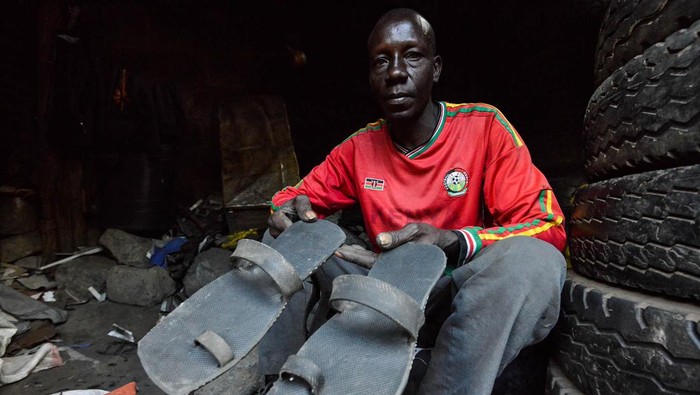 A man is seen working behind a heap of used tires at a street handcraft workshop in Nakuru Town. Approximately 280 million used tires are discarded each year, and only about 30 million of these are retreaded or reused. If not properly managed used tires end up polluting the environment. By repurposing them, artisans in Nakuru and other places are helping keep the waste from getting into the environment. (Photo by James Wakibia / SOPA Images/Sipa USA)No Use Germany.