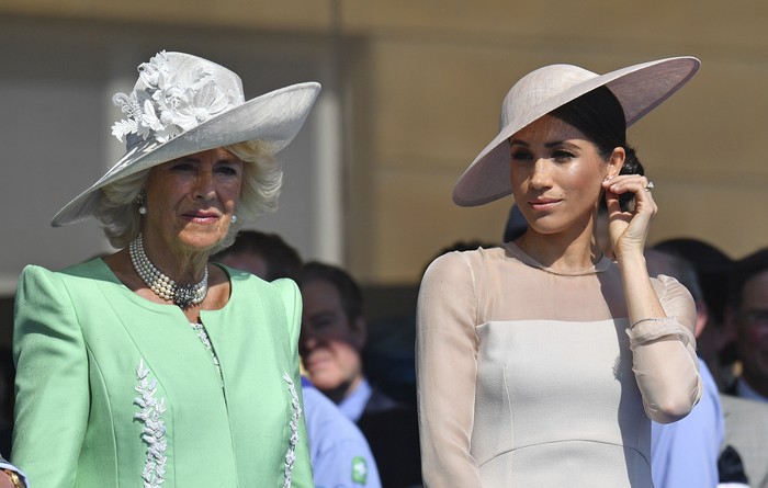 Britains King Charles III, from bottom left, Camilla, the Queen Consort, Prince Harry and Meghan, Duchess of Sussex watch as the coffin of Queen Elizabeth II is placed into the hearse following the state funeral service in Westminster Abbey in central London Monday Sept. 19, 2022. The Queen, who died aged 96 on Sept. 8, will be buried at Windsor alongside her late husband, Prince Philip, who died last year. (AP Photo/Martin Meissner, Pool)