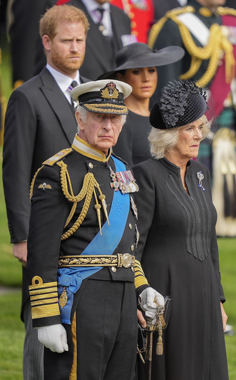 Britain's King Charles III, from bottom left, Camilla, the Queen Consort, Prince Harry and Meghan, Duchess of Sussex watch as the coffin of Queen Elizabeth II is placed into the hearse following the state funeral service in Westminster Abbey in central London Monday Sept. 19, 2022. The Queen, who died aged 96 on Sept. 8, will be buried at Windsor alongside her late husband, Prince Philip, who died last year. (AP Photo/Martin Meissner, Pool)