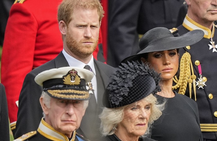Britains King Charles III, from bottom left, Camilla, the Queen Consort, Prince Harry and Meghan, Duchess of Sussex watch as the coffin of Queen Elizabeth II is placed into the hearse following the state funeral service in Westminster Abbey in central London Monday Sept. 19, 2022. The Queen, who died aged 96 on Sept. 8, will be buried at Windsor alongside her late husband, Prince Philip, who died last year. (AP Photo/Martin Meissner, Pool)