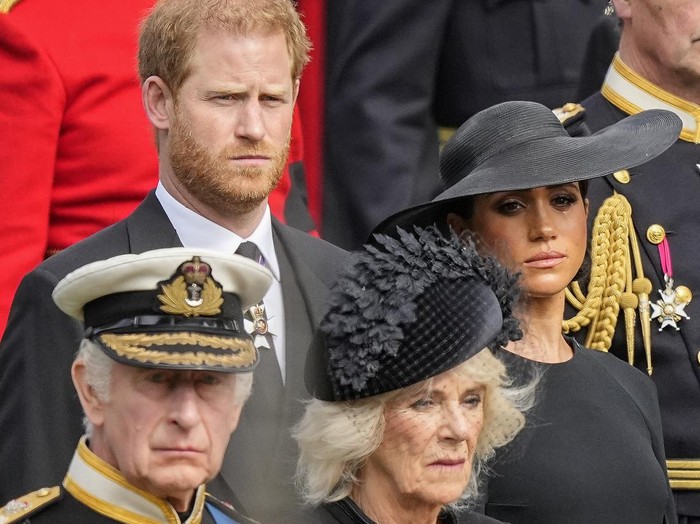 Britains King Charles III, from bottom left, Camilla, the Queen Consort, Prince Harry and Meghan, Duchess of Sussex watch as the coffin of Queen Elizabeth II is placed into the hearse following the state funeral service in Westminster Abbey in central London Monday Sept. 19, 2022. The Queen, who died aged 96 on Sept. 8, will be buried at Windsor alongside her late husband, Prince Philip, who died last year. (AP Photo/Martin Meissner, Pool)