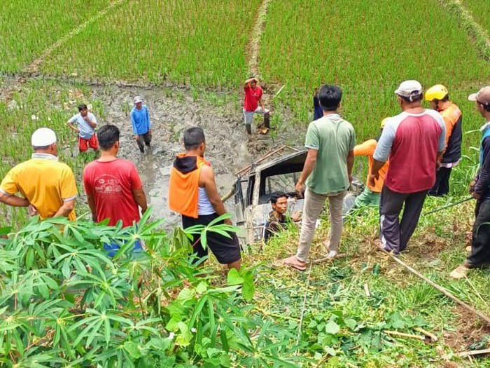 Warga dan relawan mengevakuasi mobil pikap yang tercebur jurang di Desa Plumbon, Tawangmangu, Karanganyar, Senin (9/1/2023).