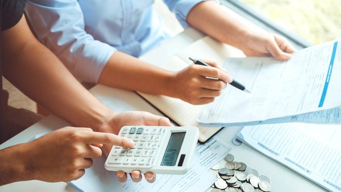 Couple using calculator Accounting Calculating Cost Economic bills with money stack step growing growth saving money in home , finance concept