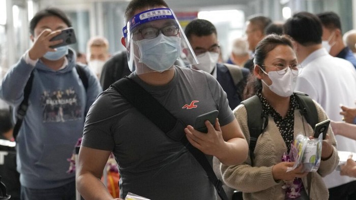 Chinese tourists arrive at Suvarnabhumi International Airport in Samut Prakarn province, Thailand, Monday, Jan. 9, 2023. Thailand is looking forward to hosting large numbers of vistors from China again after Beijing eased travel restrictions on Sunday. Chinese were about one-third of the total number of tourists visiting Thailand before the coronavirus pandemic, and the authorities hope they can help its lucrative tourism industry recover.(AP Photo/Sakchai Lalit)