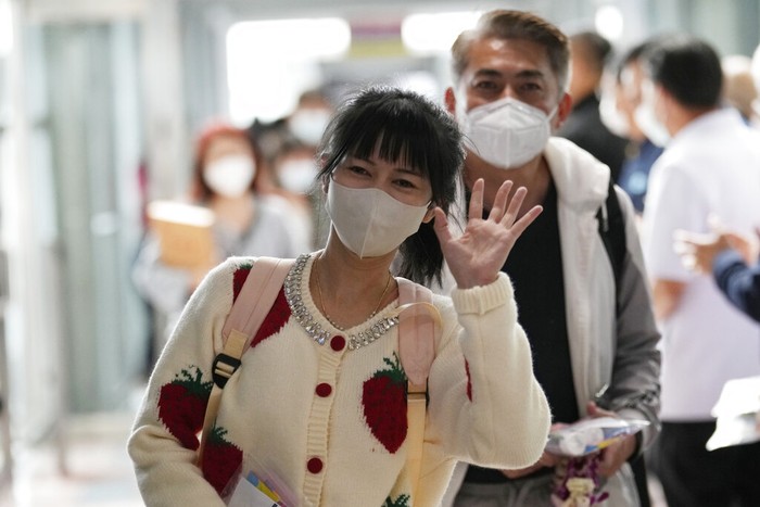 Chinese tourists arrive at Suvarnabhumi International Airport in Samut Prakarn province, Thailand, Monday, Jan. 9, 2023. Thailand is looking forward to hosting large numbers of vistors from China again after Beijing eased travel restrictions on Sunday. Chinese were about one-third of the total number of tourists visiting Thailand before the coronavirus pandemic, and the authorities hope they can help its lucrative tourism industry recover.(AP Photo/Sakchai Lalit)