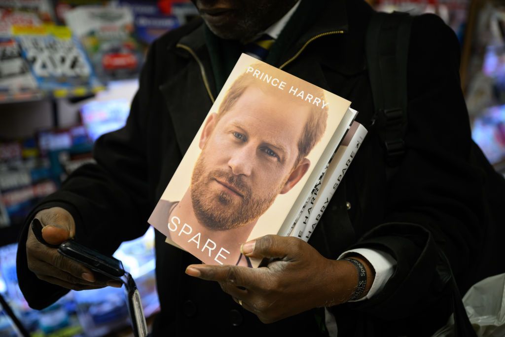 LONDON, ENGLAND - JANUARY 10: A man prepares to take a selfie as he holds copies of 