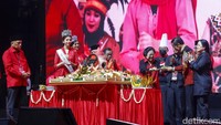 Ketua Umum PDI Perjuangan, Megawati memotong nasi tumpeng pada acara HUT PDIP ke-50. Potongan tumpeng pertama diberikan ke Jokowi.  