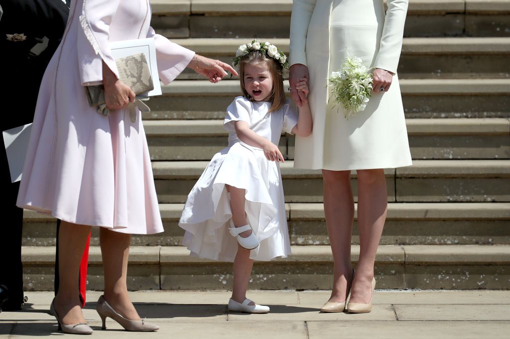 WINDSOR, UNITED KINGDOM - MAY 19:  Princess Charlotte of Cambridge stands on the steps with her mother Catherine, Duchess of Cambridge after the wedding of Prince Harry and Ms. Meghan Markle at St George's Chapel at Windsor Castle on May 19, 2018 in Windsor, England. (Photo by Jane Barlow - WPA Pool/Getty Images)