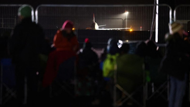 People watch Britain's first satellite launch on a screen, at Cornwall Airport Newquay, in Cornwall, Britain January 9, 2023. REUTERS/Henry Nicholls