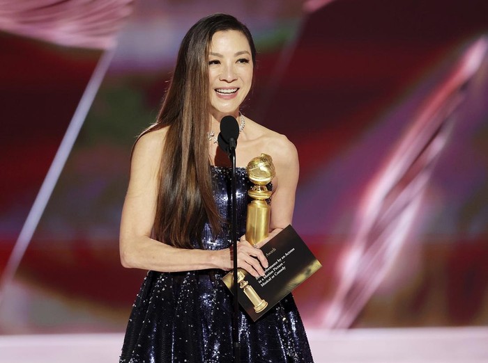 This image released by NBC shows Michelle Yeoh accepting the Best Actress in a Motion Picture – Musical or Comedy award for 