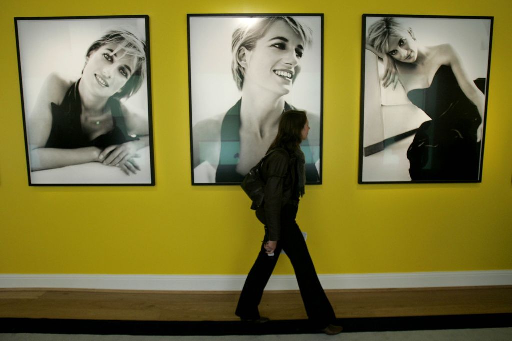 A woman walks past images of Diana, Princess of Wales by the Peruvian photographer Mario Testino in a new exhibition of his work at Kensington Palace in London, Tuesday Nov. 22, 2005.  The exhibition, which opens to the public on November 24 and runs until spring 2007, contains some images of Princess Diana that have never been displayed before and a selection of dresses worn by the princess that were later auctioned in 1997.  The main part of the exhibition is formed by 15 images shot in 1997, a project that turned out to be the last official portrait photography of the princess.  (AP Photo/Matt Dunham)