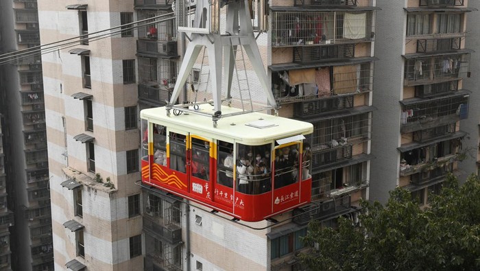 CHONGQING, CHINA - JANUARY 10: A view of a cable car across the Yangtze River on January 10, 2023 in Chongqing, China. The Yangtze River Cableway reopened on January 9 after an upgrade. (Photo by Zhou Yi/China News Service/VCG via Getty Images)