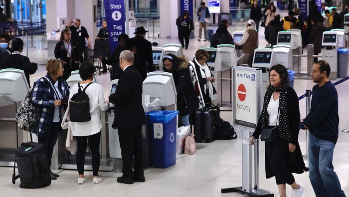 Passengers check in for flights at Newark International Airport, in Newark, New Jersey, on January 11, 2023. - The US Federal Aviation Authority  said Wednesday that normal flight operations 
