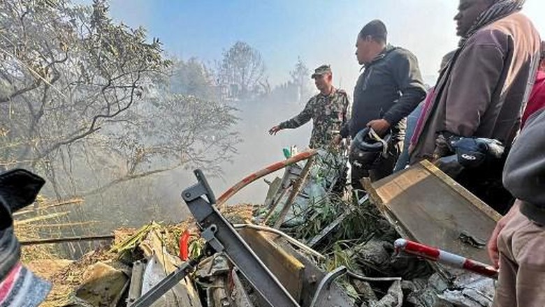 Rescuers inspect the site of a plane crash in Pokhara on January 15, 2023. - An aircraft with 72 people on board crashed in Nepal on January 15, Yeti Airlines and a local official said. (Photo by Yunish Gurung / AFP)