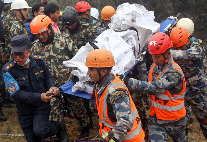 A rescue team recovers the body of a victim from the site of the plane crash of a Yeti Airlines operated aircraft on January 15, 2023, in Pokhara, Nepal January 16, 2023. REUTERS/Bijay Neupane NO RESALES. NO ARCHIVES