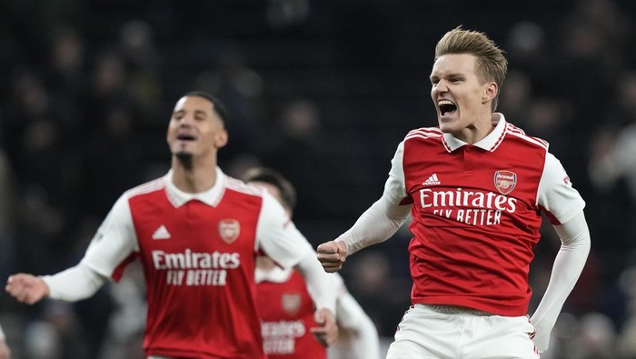 Arsenals William Saliba, left, and Arsenals Martin Odegaard celebrate their victory at the English Premier League soccer match between Tottenham Hotspur and Arsenal at the Tottenham Hotspur Stadium in London, England, Sunday, Jan. 15, 2023. (AP Photo/Frank Augstein)