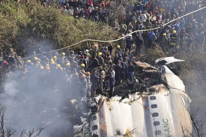 Nepalese rescue workers and civilians gather around the wreckage of a passenger plane that crashed in Pokhara, Nepal, Sunday, Jan. 15, 2023. Authorities in Nepal said 68 people have been confirmed dead after a regional passenger plane with 72 aboard crashed into a gorge while landing at a newly opened airport in the resort town of Pokhara. Its the countrys deadliest airplane accident in three decades. (AP Photo/Krishna Mani Baral)