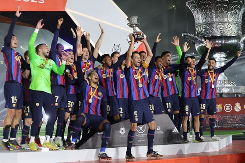 Barcelonas players celebrate on the podium after winning the Spanish Super Cup final football match between Real Madrid CF and FC Barcelona at the King Fahd International Stadium in Riyadh, Saudi Arabia, on January 15, 2023. (Photo by Giuseppe CACACE / AFP) (Photo by GIUSEPPE CACACE/AFP via Getty Images)