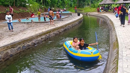 Pengunjung saat menikmati wahana bermain perahu karet di alas utama medewi (AUM) yang berlokasi di Banjar Baler Setra, Desa Medewi, Kecamatan Pekutatan, Kabupaten Jembrana, Minggu (16/1/2023). (I Putu Adi Budiastrawan/detikBali).