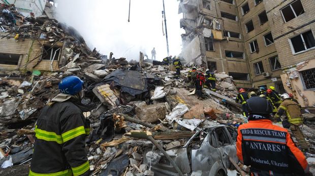 DNIPRO, UKRAINE - JANUARY 15: Rescuers search people trapped under the rubble of a high-rise residential building hit by a missile on January 15, 2023 in Dnipro, Ukraine. On January 14, Russia launched a new massive attack on Ukrainian cities. In Dnipro, one of the Х-22 cruise missiles hit a nine-story residential building, completely destroying one of the sections from top to bottom floors. The number of dead has increased to 29 people, with rescue work continuing. More than 40 residents of the building are still being searched. (Photo by Yurii Stefanyak/Global Images Ukraine via Getty Images)
