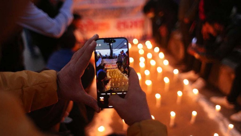KATHMANDU, NEPAL- JANUARY 16: People hold candles during a vigil in memory of victims of a plane crash of a Yeti Airlines operated aircraft in Pokhara on January 15 in Kathmandu, Nepal on January 16, 2023. (Photo by Sunil Pradhan/Anadolu Agency via Getty Images)