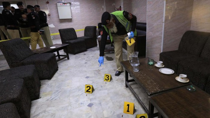 A police officer surveys the crime scene after, according to police, a gunman killed Abdul Latif Afridi, lawyer and former president of Pakistan’s Supreme Court Bar Association, in Peshawar, Pakistan January 16, 2023. REUTERS/Fayaz Aziz