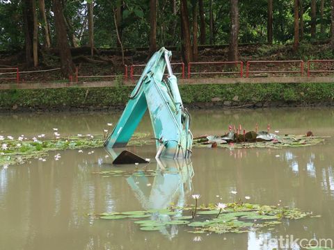 Satu unit eskavator yang terjebak di danau buatan atau area 2 Kebun Buah Mangunan, Kabupaten Bantul. Selasa (17/1/2022).