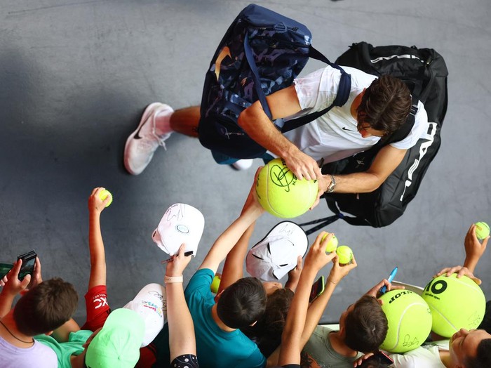 Tennis - Australian Open - Melbourne Park, Melbourne, Australia - January 17, 2023 Taylor Fritz of the U.S. signs autographs for fans after winning his first round match against Georgias Nikoloz Basilashvili REUTERS/Carl Recine