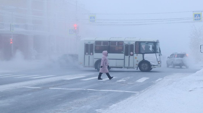 A car drives along a road on a frosty day in Yakutsk, Russia, January 15, 2023. Yakutsk, one of the Russia's north-most cities, is hit by an extreme cold snap as the air temperature on Sunday (January 15) plunged as low as minus 51 degrees Celsius (minus 59.8 degrees Fahrenheit). REUTERS/Roman Kutukov