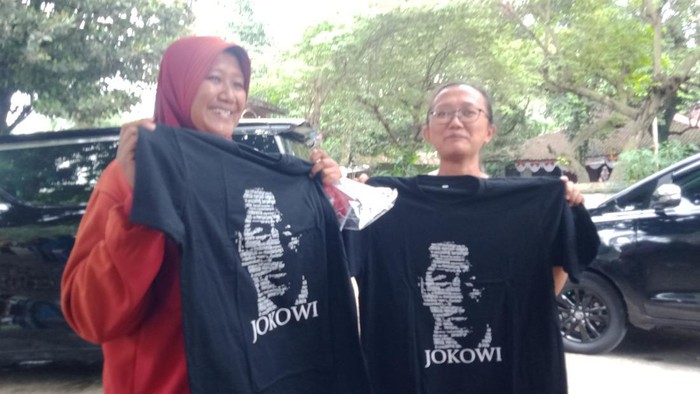 Warga menunjukkan kaus dan buku yang dibagikan Iriana Jokowi di Polanharjo, Klaten, Rabu (18/1/2023).