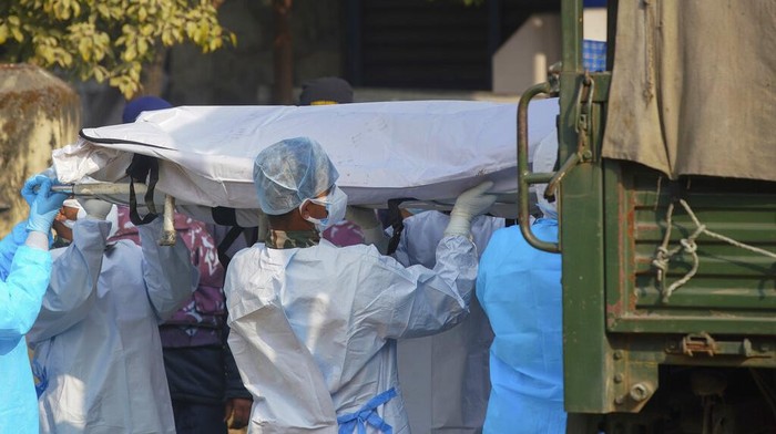Medical personnel load the body of a victim onto a truck to be transported to Kathmandu, in Pokhara, Nepal, Tuesday, Jan 17, 2023. Nepalese authorities on Tuesday began returning to families the bodies of victims of a flight that crashed Sunday, and said they were sending the aircraft's data recorder to France for analysis as they try to determine what caused the country's deadliest plane accident in 30 years. (AP Photo/Yunish Gurung)