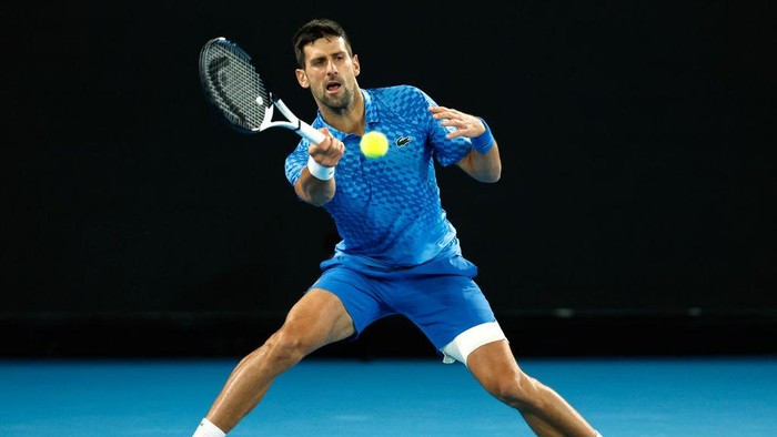 MELBOURNE, AUSTRALIA - JANUARY 19: Novak Djokovic of Serbia plays a forehand in their round two singles match against Enzo Couacauo of France during day four of the 2023 Australian Open at Melbourne Park on January 19, 2023 in Melbourne, Australia. (Photo by Darrian Traynor/Getty Images)