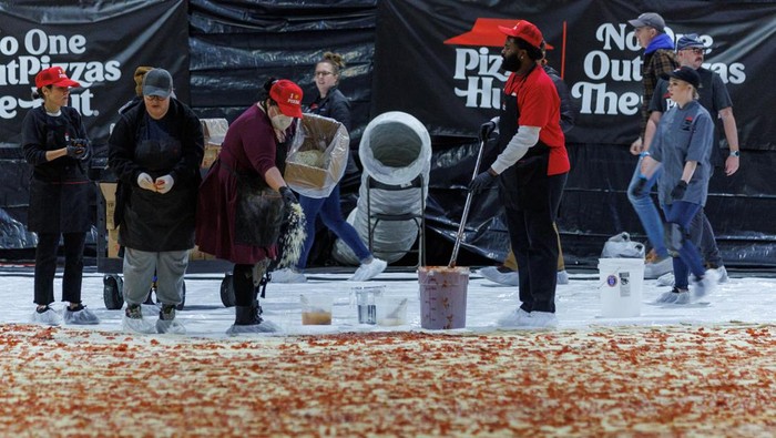 Cooks work inside the Los Angels Convention center as Pizza Hut attempts to create the World's largest pizza of 14,101 square feet in Los Angeles, California, U.S., January 18, 2023.   REUTERS/Mike Blake