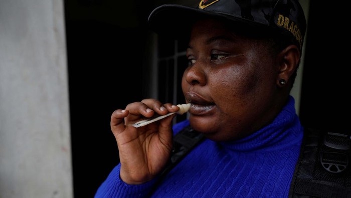 Evelyn Ogolo, 27, a member of the female-only security team Dragon Squad Limited, applies lipbalm as she gets ready to work at an event in Uyo, Akwa Ibom, Nigeria, October 29, 2022. Founded in 2018, Emem Thomas, 37, only employs women of a certain weight and shape, creating a safe space for plus-size women to excel in a field that is traditionally male-dominated. 