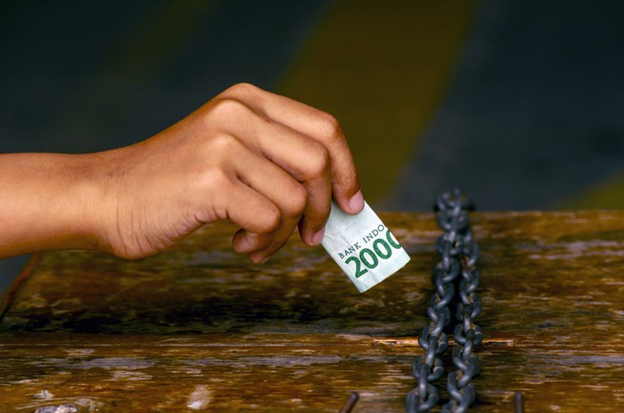 Infaq, an asian child hand put money in a charity box for donation