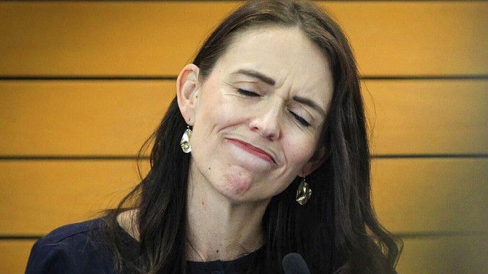New Zealand Prime Minister Jacinda Ardern grimaces as she announces her resignation at a press conference in Napier, New Zealand. Fighting back tears, Ardern told reporters that Feb. 7 will be her last day in office. (Warren Buckland/New Zealand Herald via AP)