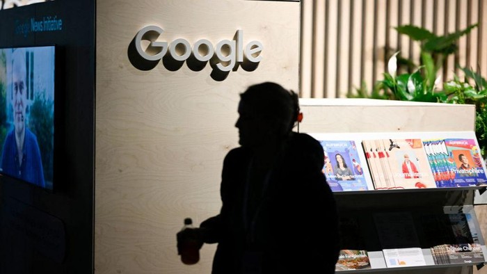 A woman passes by a booth of Google at the re:publica 2022 digital media convention in Berlin, on June 9, 2022. - The festival for the digital society runs from June 8-10, 2022. (Photo by Tobias SCHWARZ / AFP) (Photo by TOBIAS SCHWARZ/AFP via Getty Images)