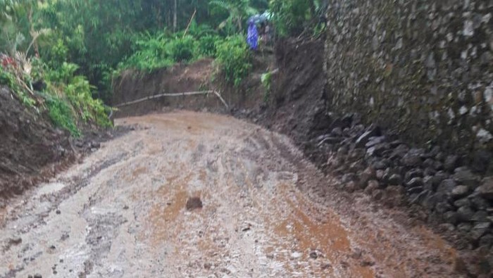 Ruas jalan di Desa Sibetan, Kecamatan Bebandem, Karangasem, Bali, tertutup lumpur setelah diguyur hujan deras, Jumat (20/1/2023).