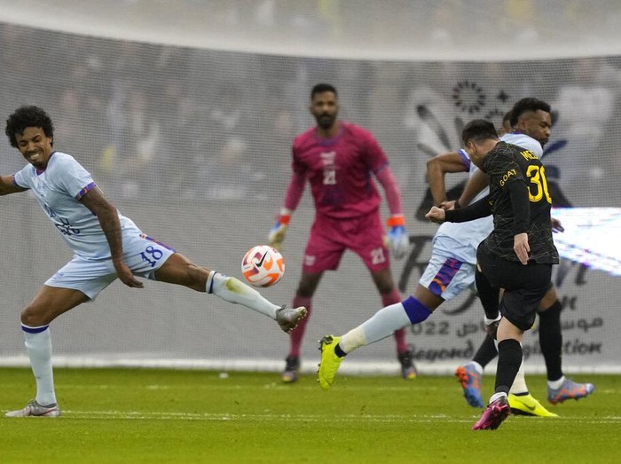 PSG's Lionel Messi makes an attempt to score as he plays against a combined XI of Saudi Arabian teams Al Nassr and Al Hilal during a friendly soccer match, at the King Saud University Stadium, in Riyadh, Saudi Arabia, Thursday, Jan. 19, 2023. (AP Photo/Hussein Malla)