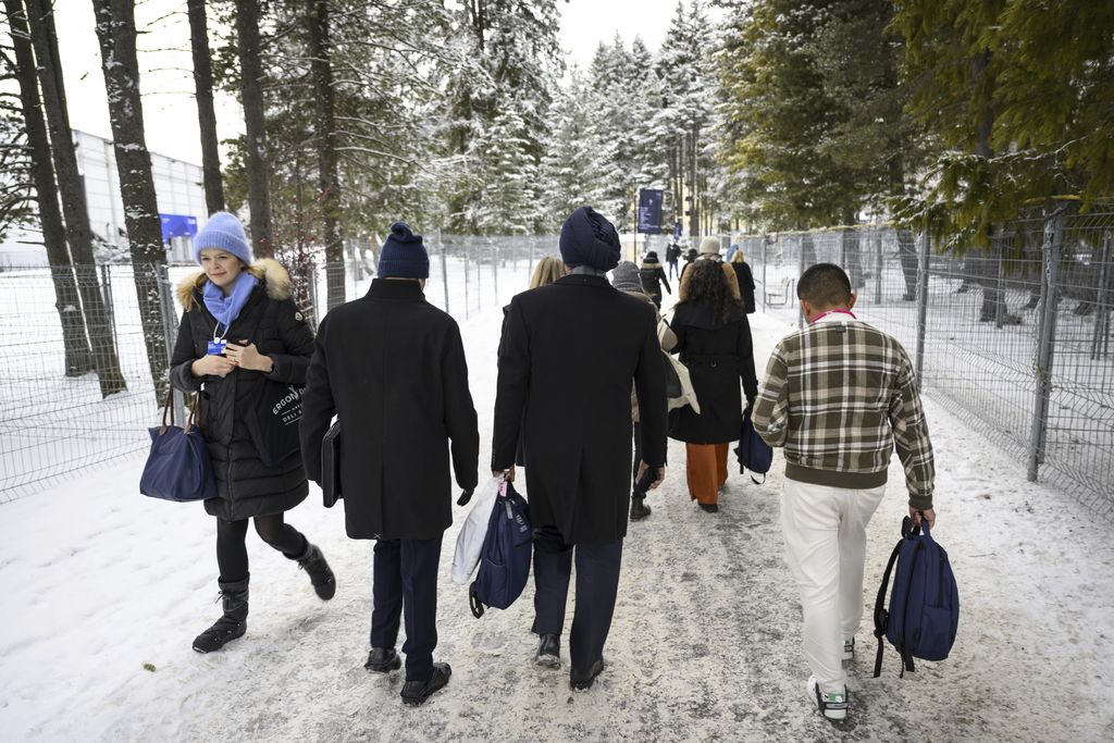 Participants walk on a snow covered path outside the Congress Centre during the 53rd annual meeting of the World Economic Forum, WEF, in Davos, Switzerland, Monday, Jan 16, 2023. The meeting brings together entrepreneurs, scientists, corporate and political leaders in Davos under the topic 